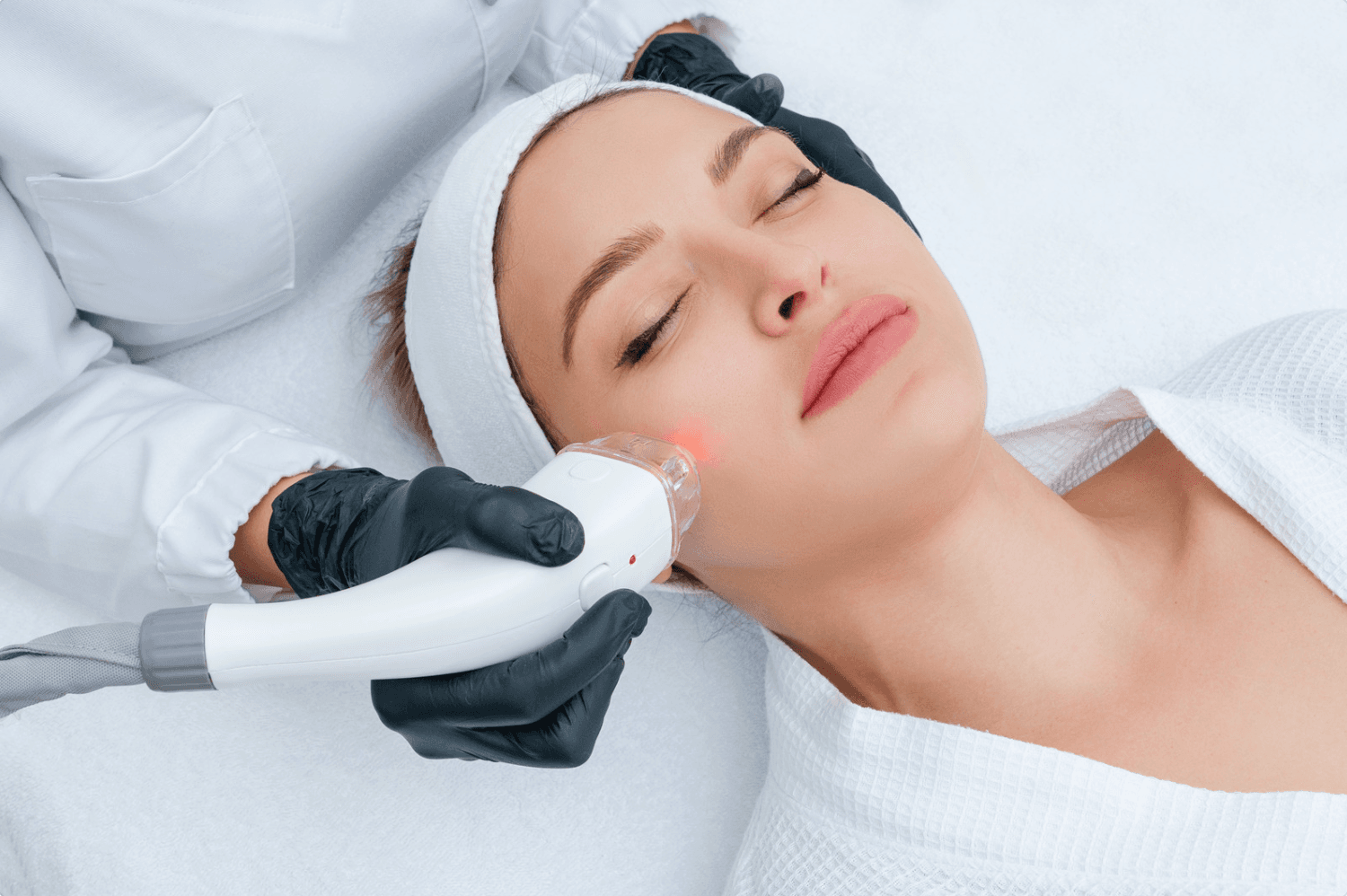 woman receiving laser treatment on face